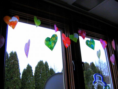 Heart decorations hanging from window