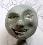 Sculpted face and sketch for boy sculpture