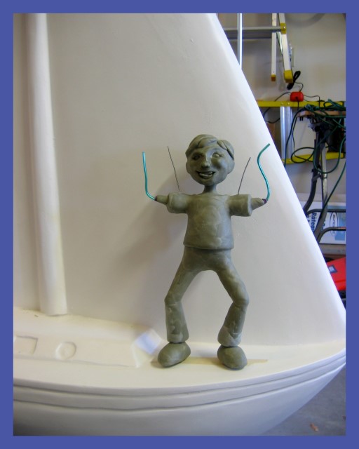 Boy sculpture on sailboat
