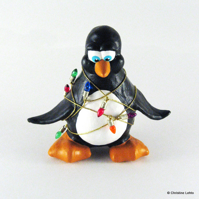 Penguin sculpture wrapped in Christmas lights