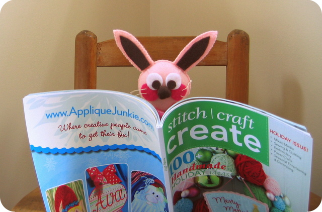 Ralphie looking at glitter ornaments article in Stitch Craft Create magazine article