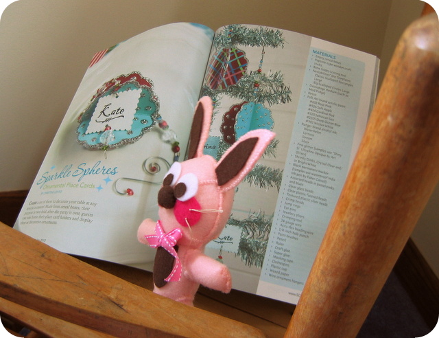 Ralphie with Holiday 2012 issue of Stitch Craft Creat to read glitter oranmetn article